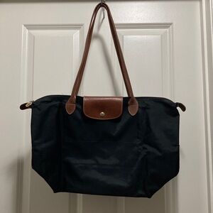 Longchamp Nylon Black Tote with Brown leather handles & snap closure flap.
